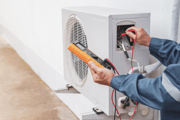 Man performing AIM act HVAC maintenance 